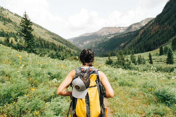 Hiker looking at mountains and lake